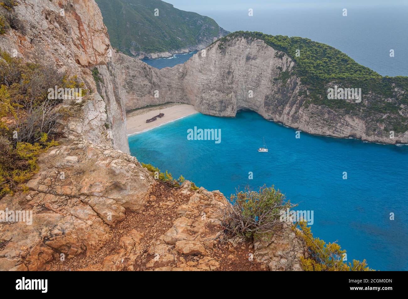 Panorama of the cove of the shipwreck beach and its white limestone cliffs and catamaran moored, Zakynthos island, Greece Stock Photo