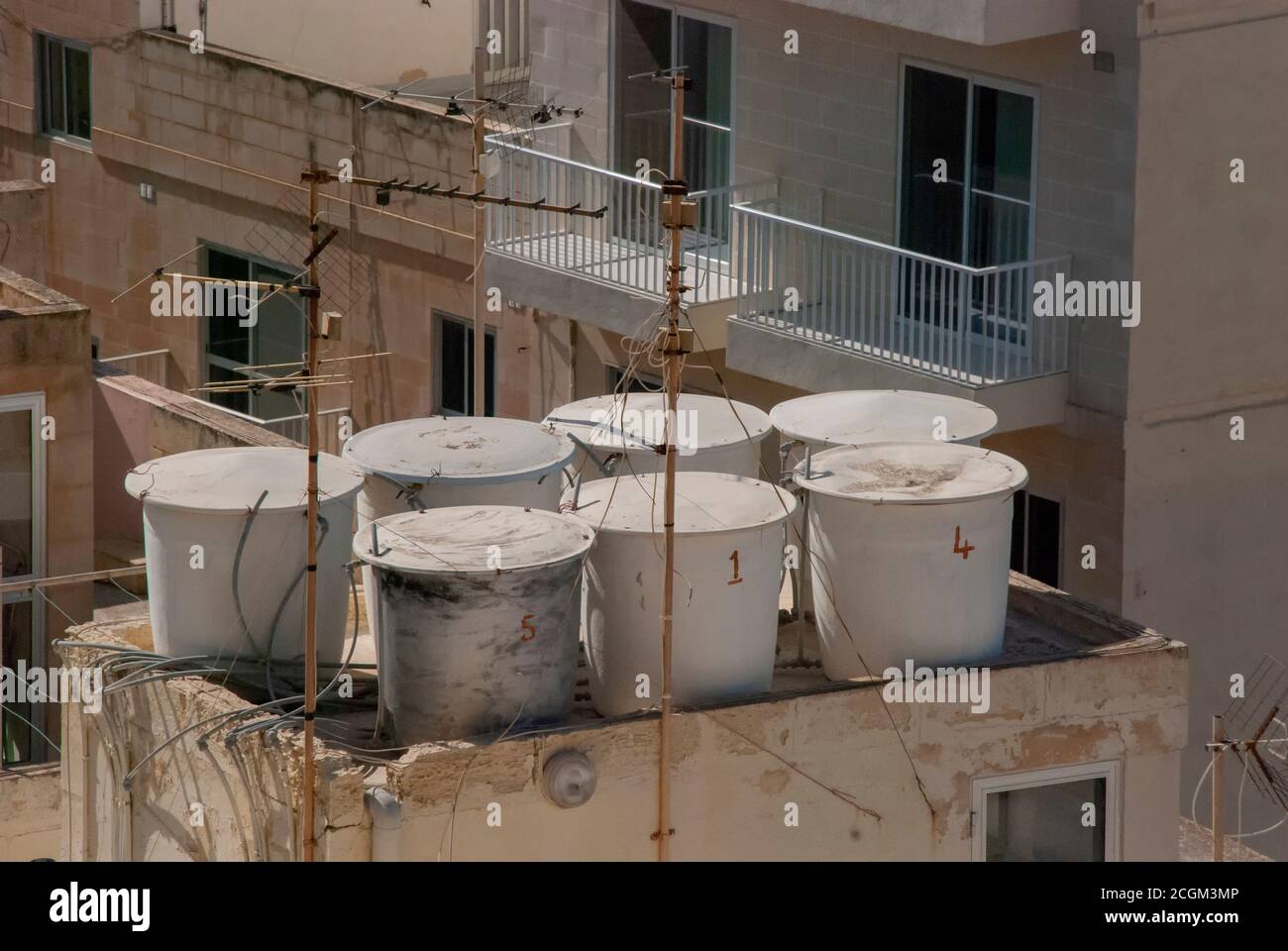 Water tanks on the roof tops of a building in a town in Malta Stock