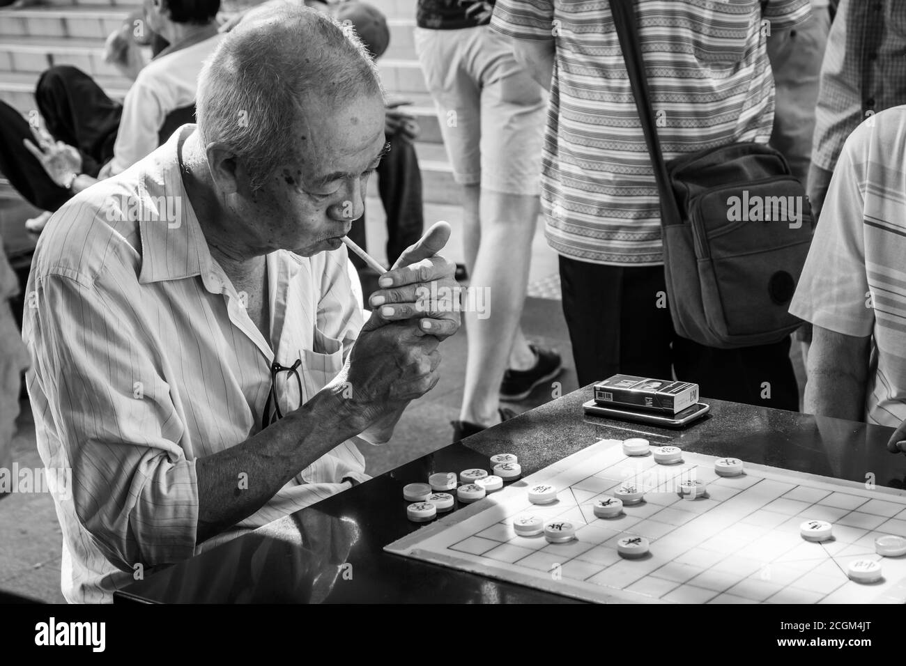 Chinatown, Singapore - 11 2018: Old man playing Xiangqi, chinese chess Stock Photo