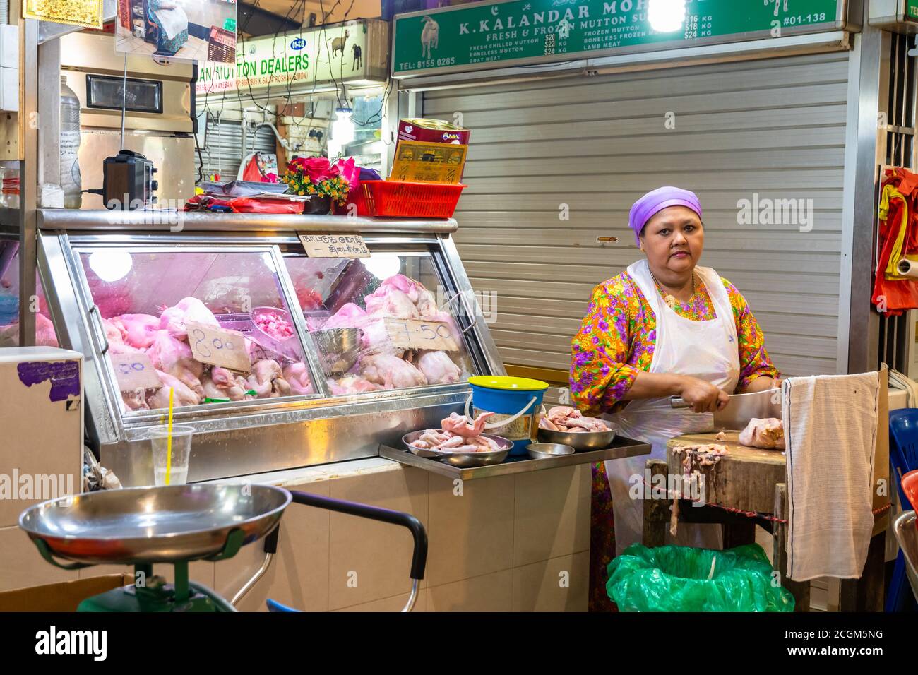 Singapore - 11 2018: Butcher at work at Tekka Indian market Stock Photo