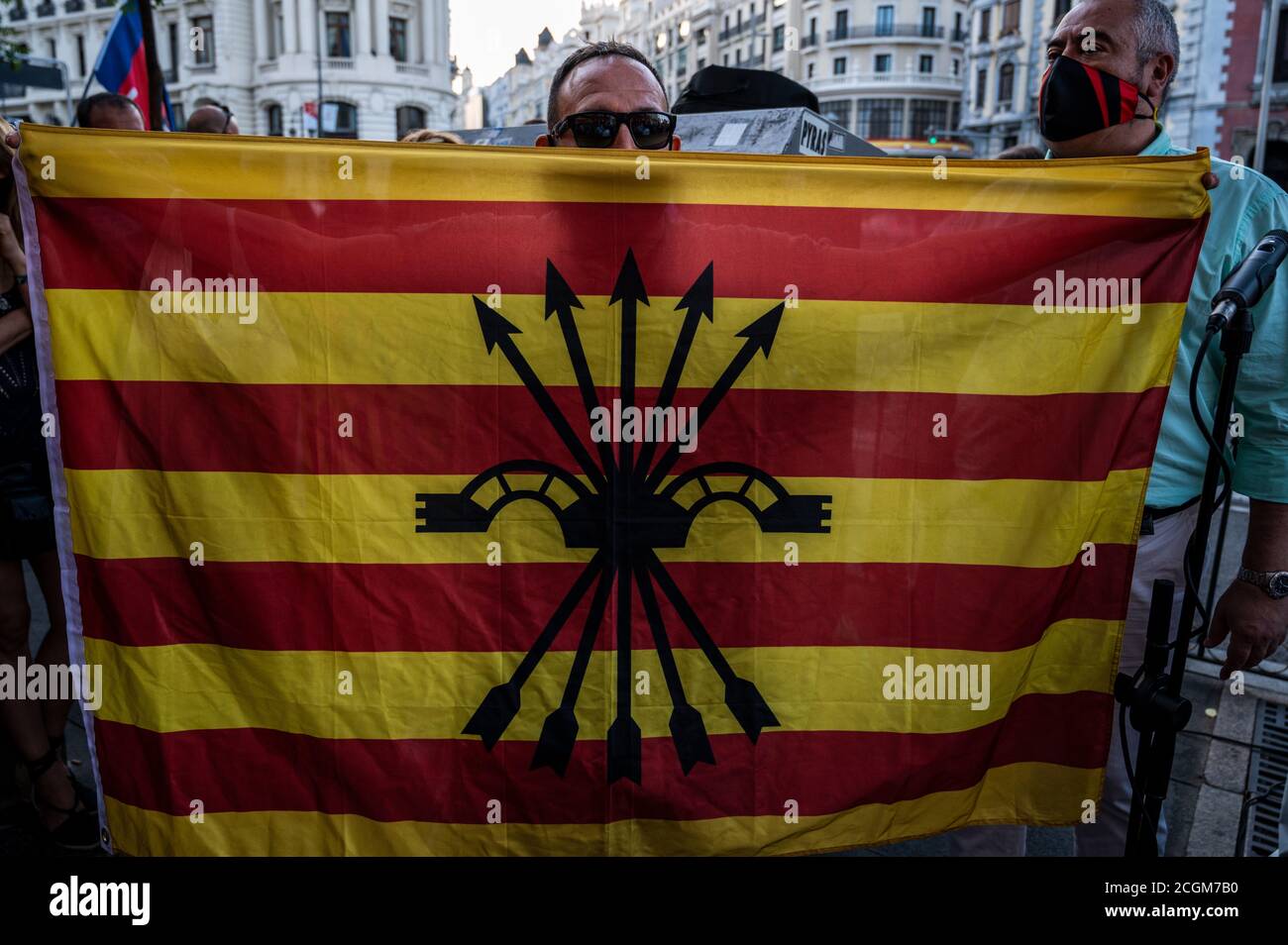 Madrid, Spain. 11th Sep, 2020. A supporter of far right wing holds a 'Phalanx' flag during a protest against the Blanquerna case coinciding with the celebration of the 'Diada' National Day in Catalonia. Credit: Marcos del Mazo/Alamy Live News Stock Photo