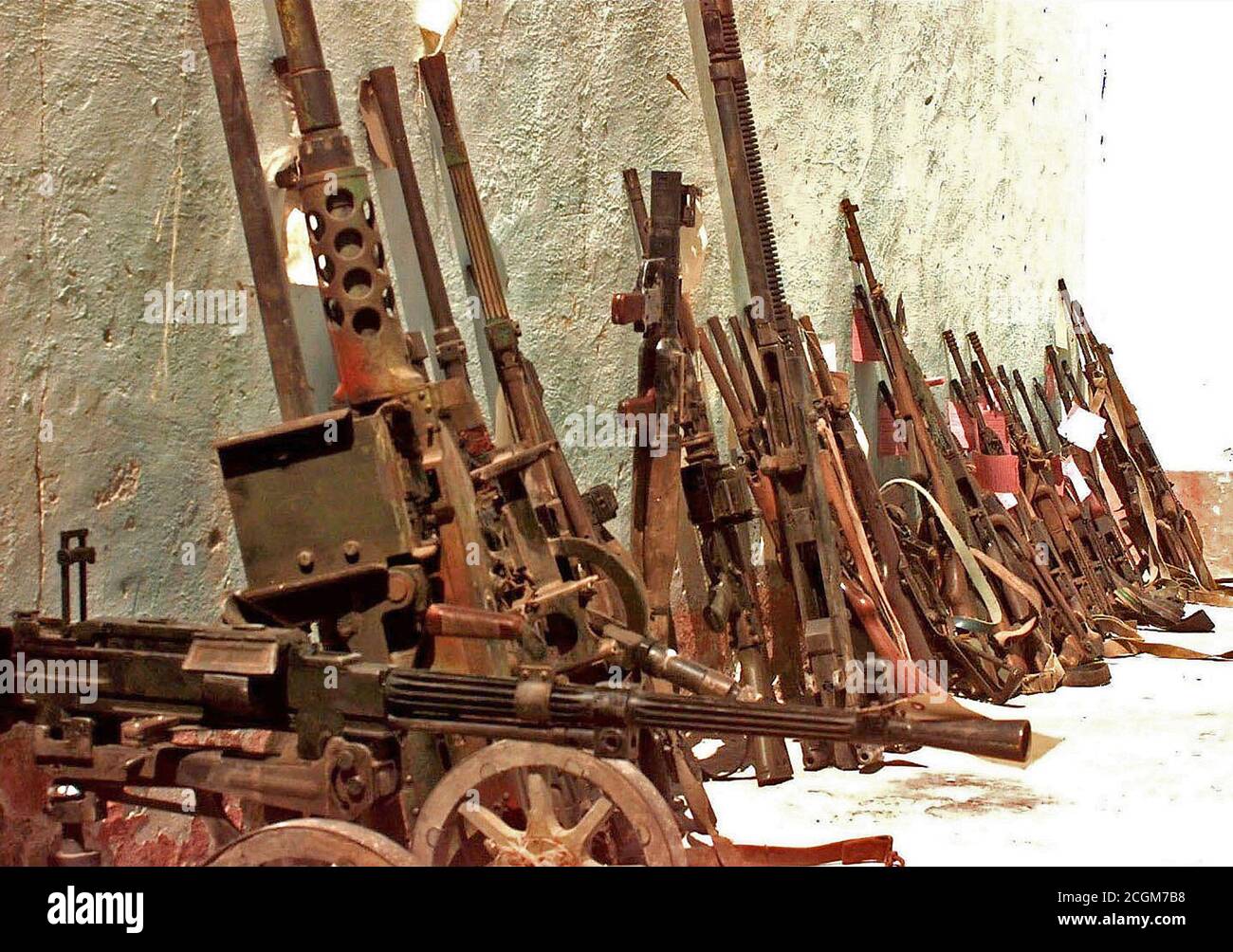 1993 - Confiscated Somali weapons at checkpoint Condor in Marka, Somalia.  They are mostly small arms and crew weapons that are lined up against the wall of a building. Stock Photo