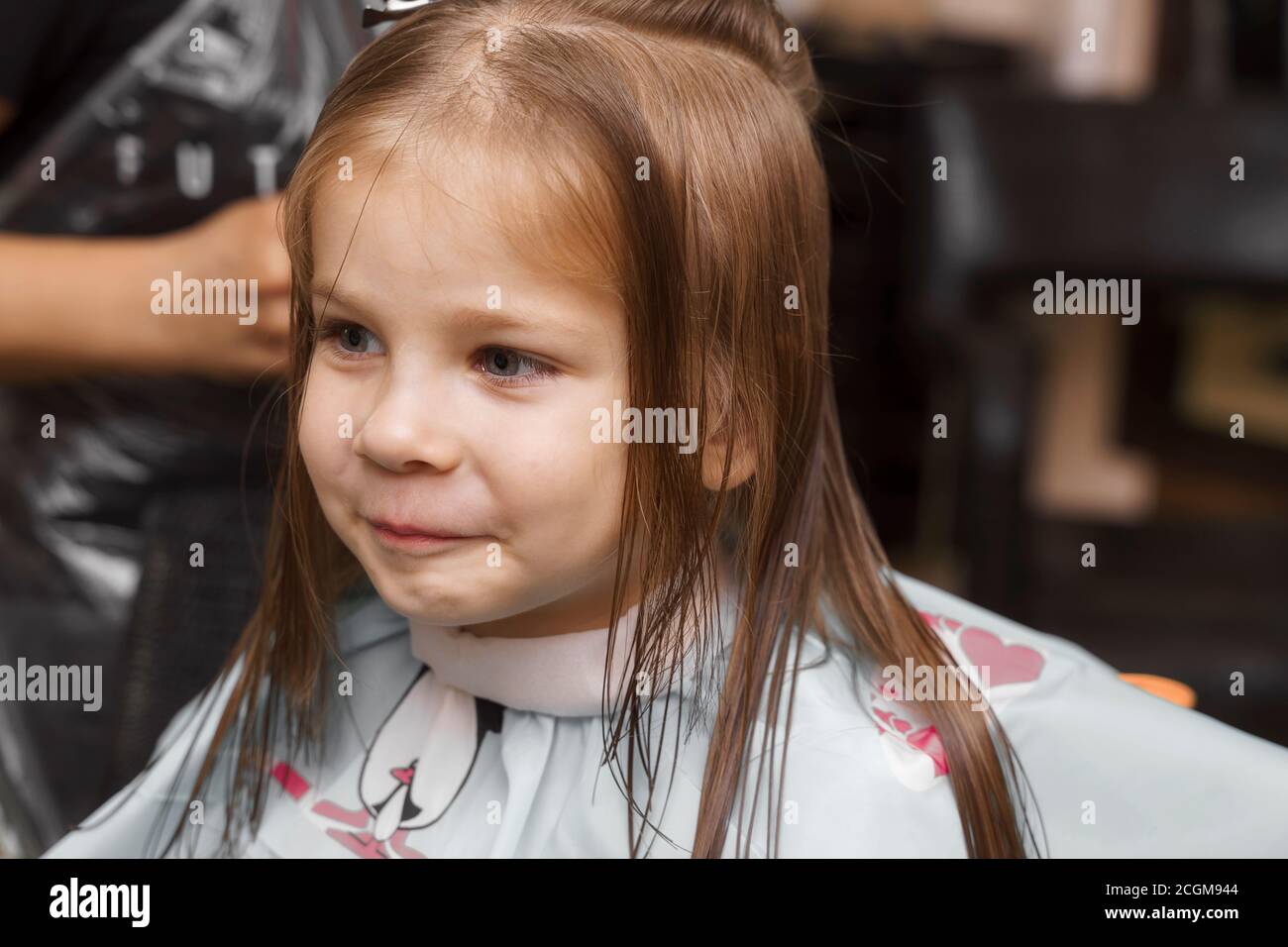 beautiful little red-haired girl at the barber shop.girl smiling in the ...