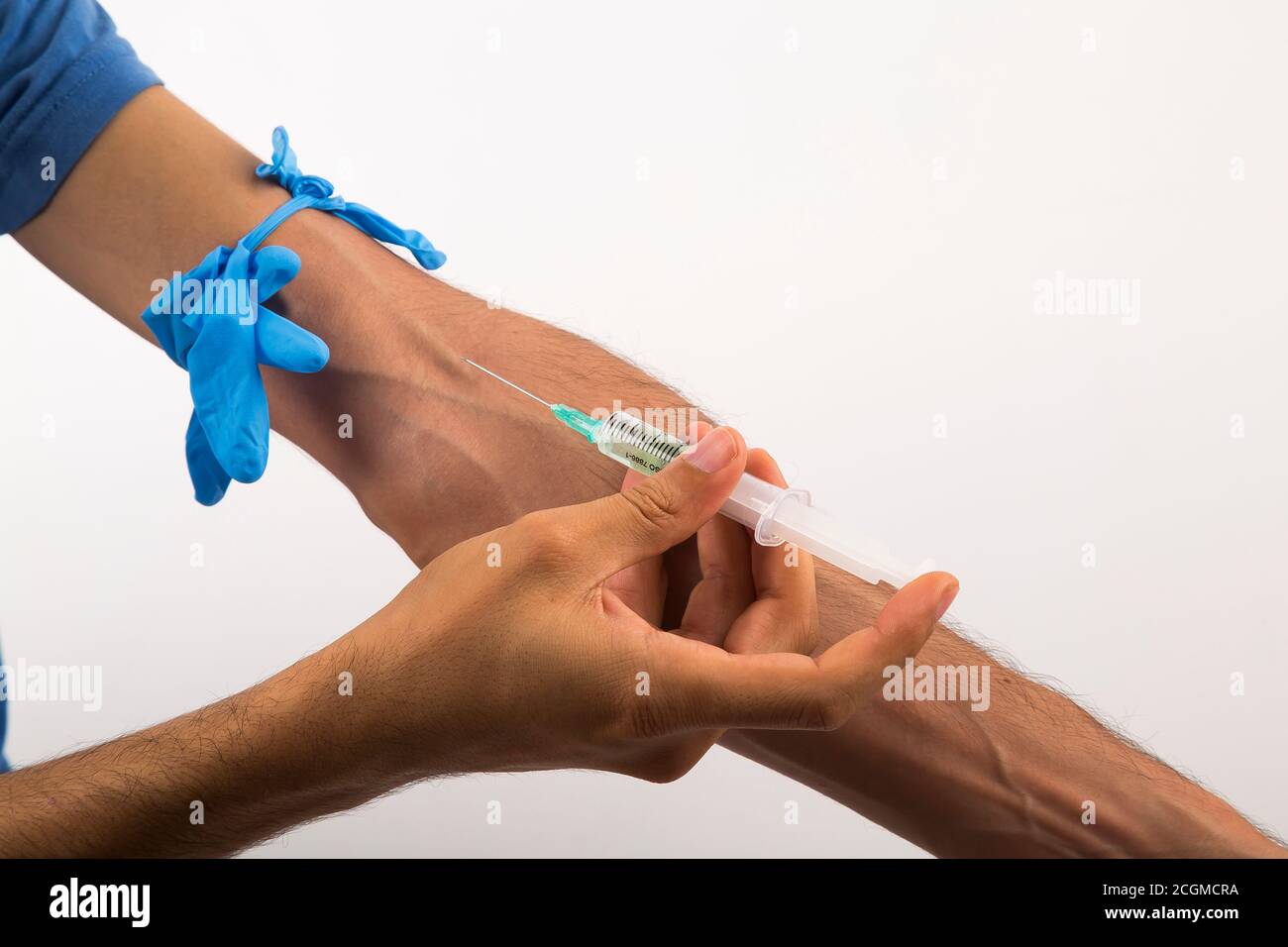 Drug addiction, male using drugs in syringe, white and isolated background Stock Photo
