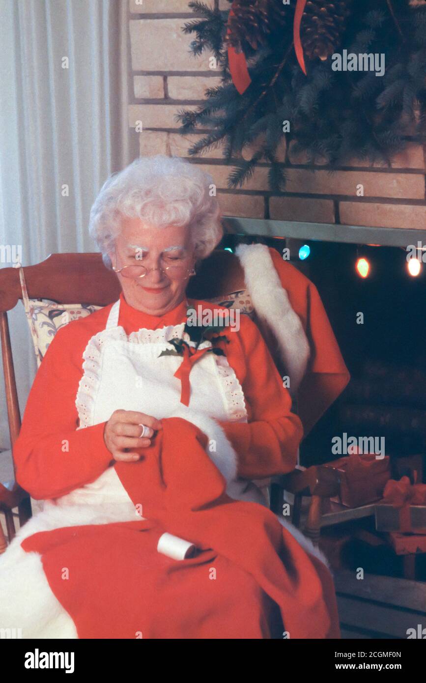 Mrs. Santa Claus is mending Santa's Hat, North Pole Stock Photo