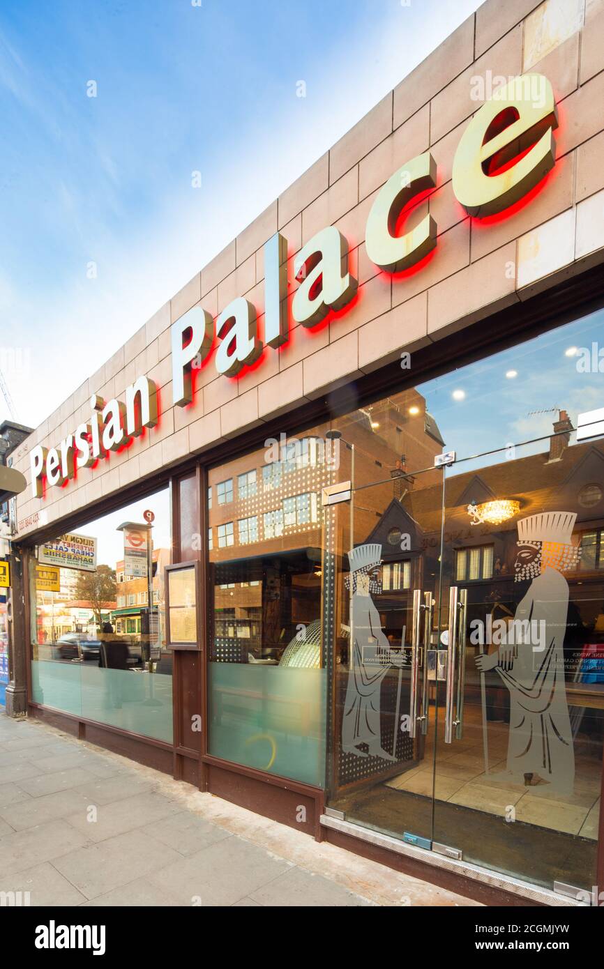 Persian Palace (Ealing) Bright dining room and takeaway with tiled floors and rollback chairs, serving Iranian grill menu Stock Photo