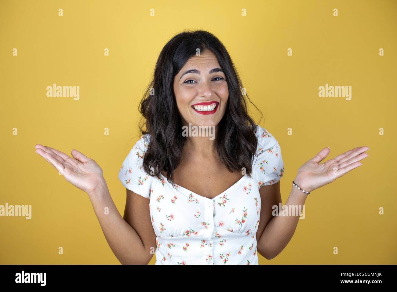 Beautiful woman over yellow background clueless and confused expression ...