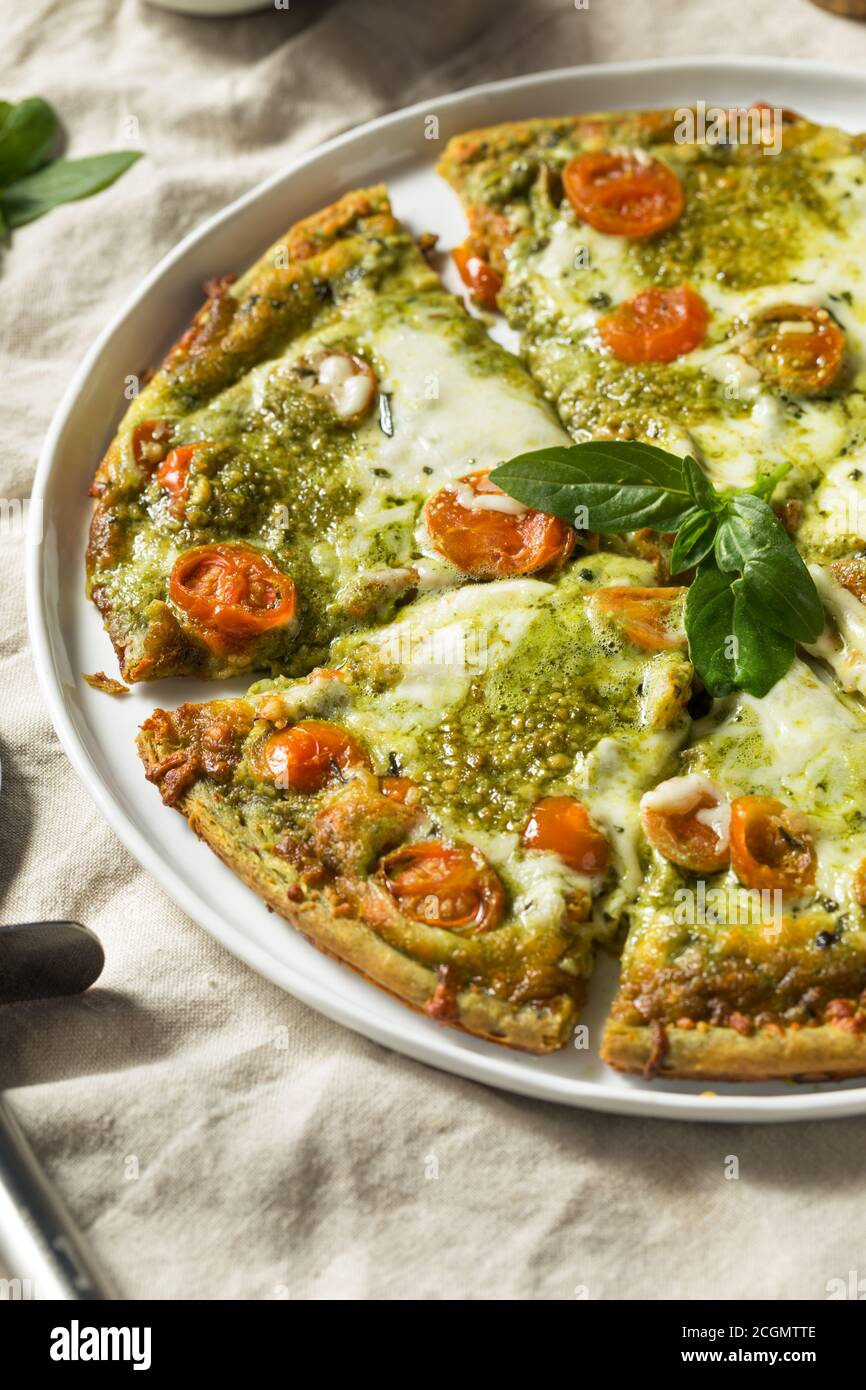 Homemade Green Pesto Pizza with Mozzarella and Tomatoes Stock Photo Alamy