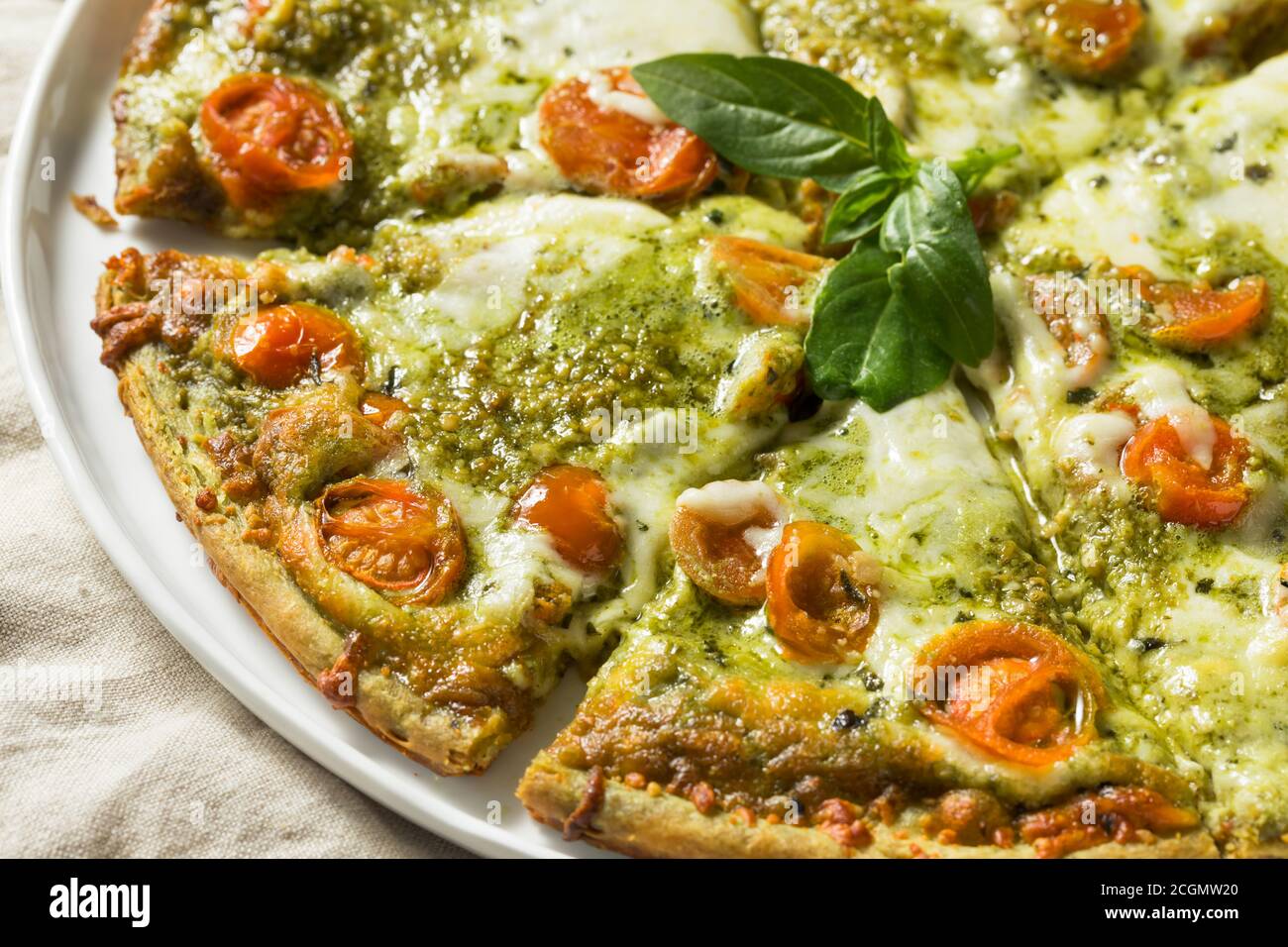 Homemade Green Pesto Pizza with Mozzarella and Tomatoes Stock Photo Alamy