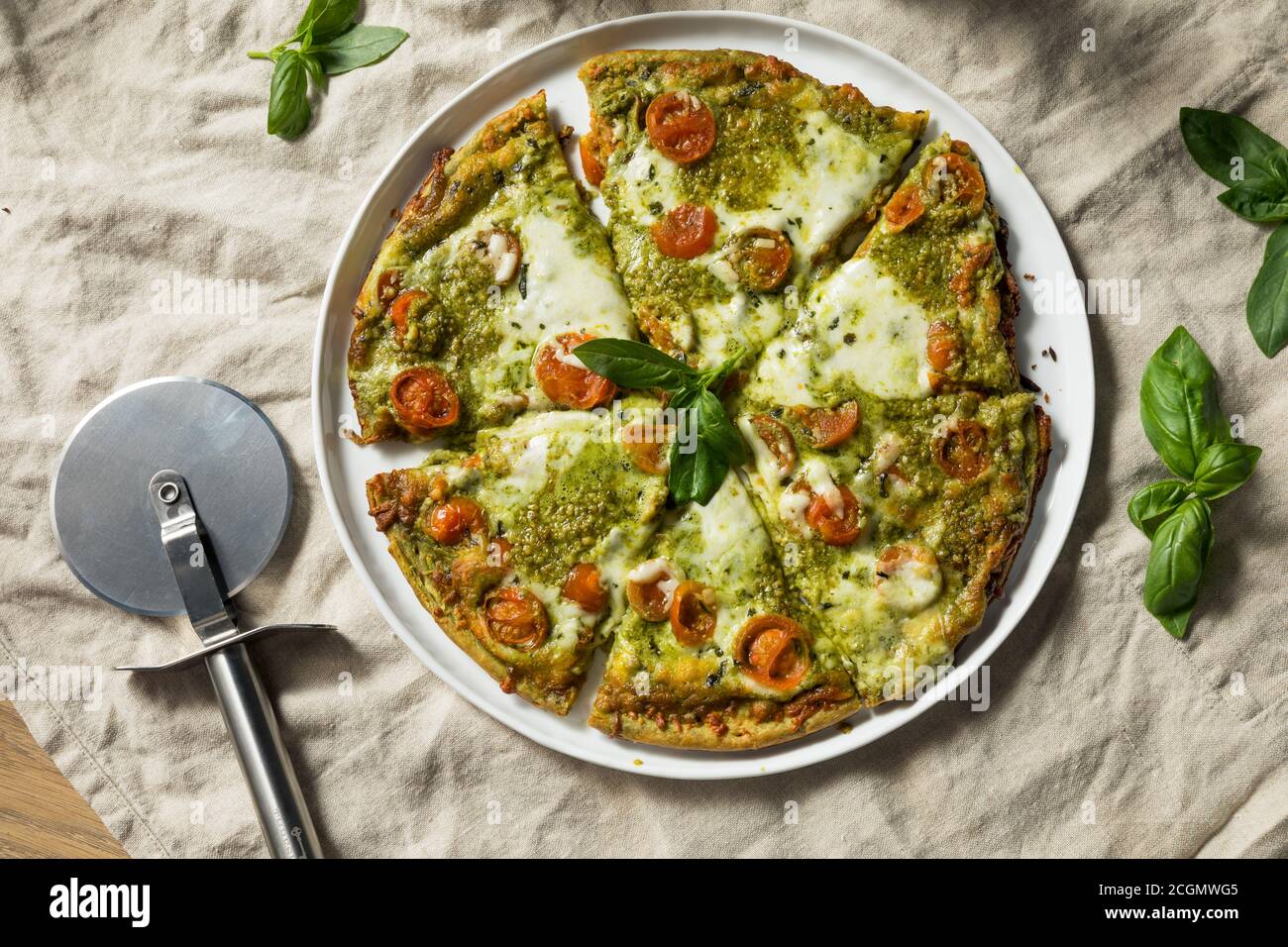 Homemade Green Pesto Pizza with Mozzarella and Tomatoes Stock Photo Alamy
