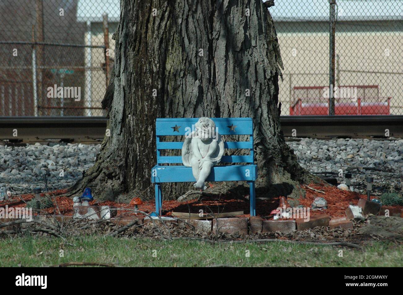concrete angel on a blue bench Stock Photo Alamy