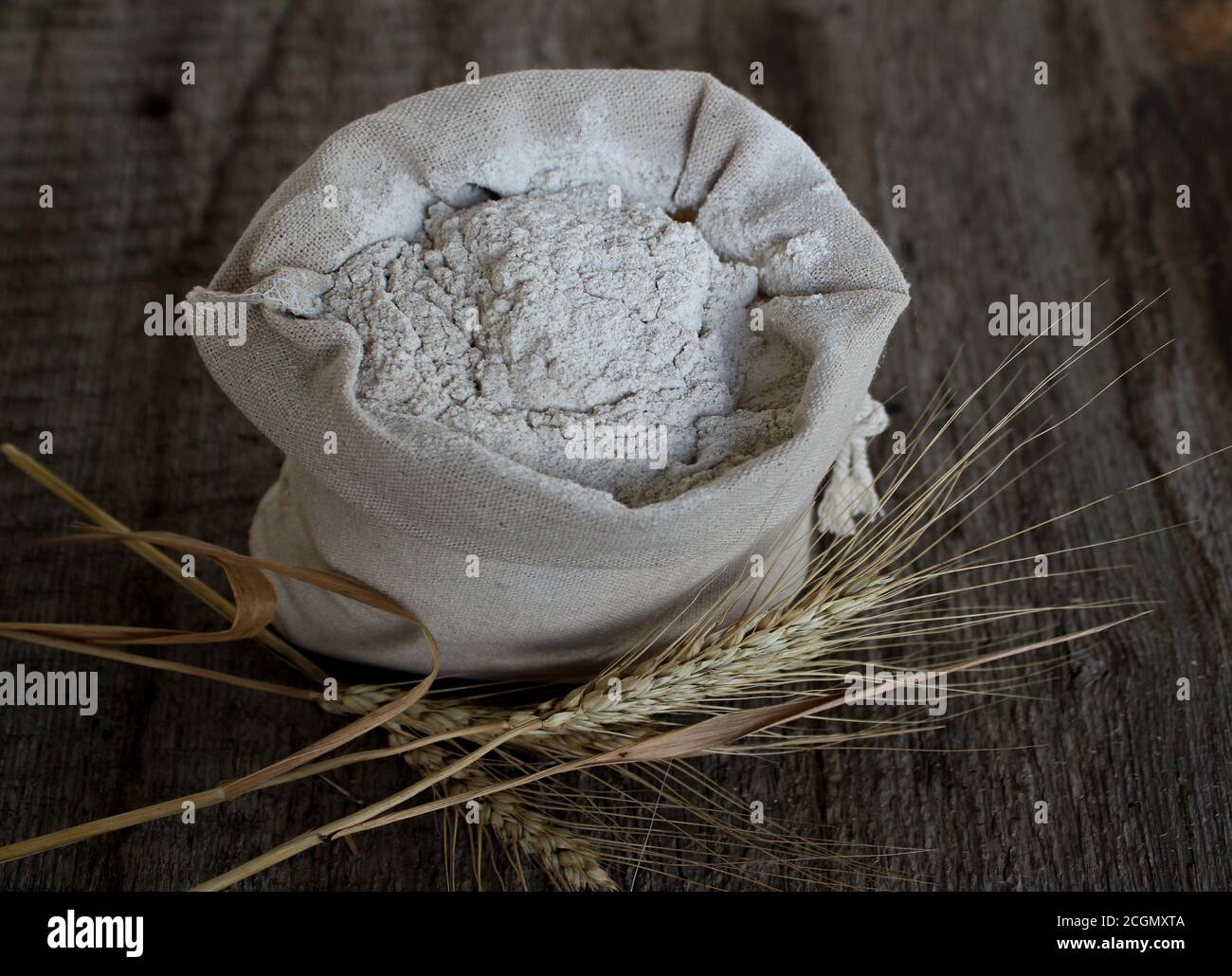 Wheat weazing and a linen bag with flour. Stock Photo