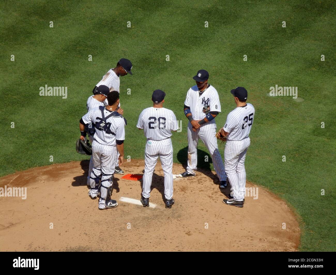 New York Yankees players have a discussion on the pitcher's mound, Yankee Stadium, New York City, United States Stock Photo