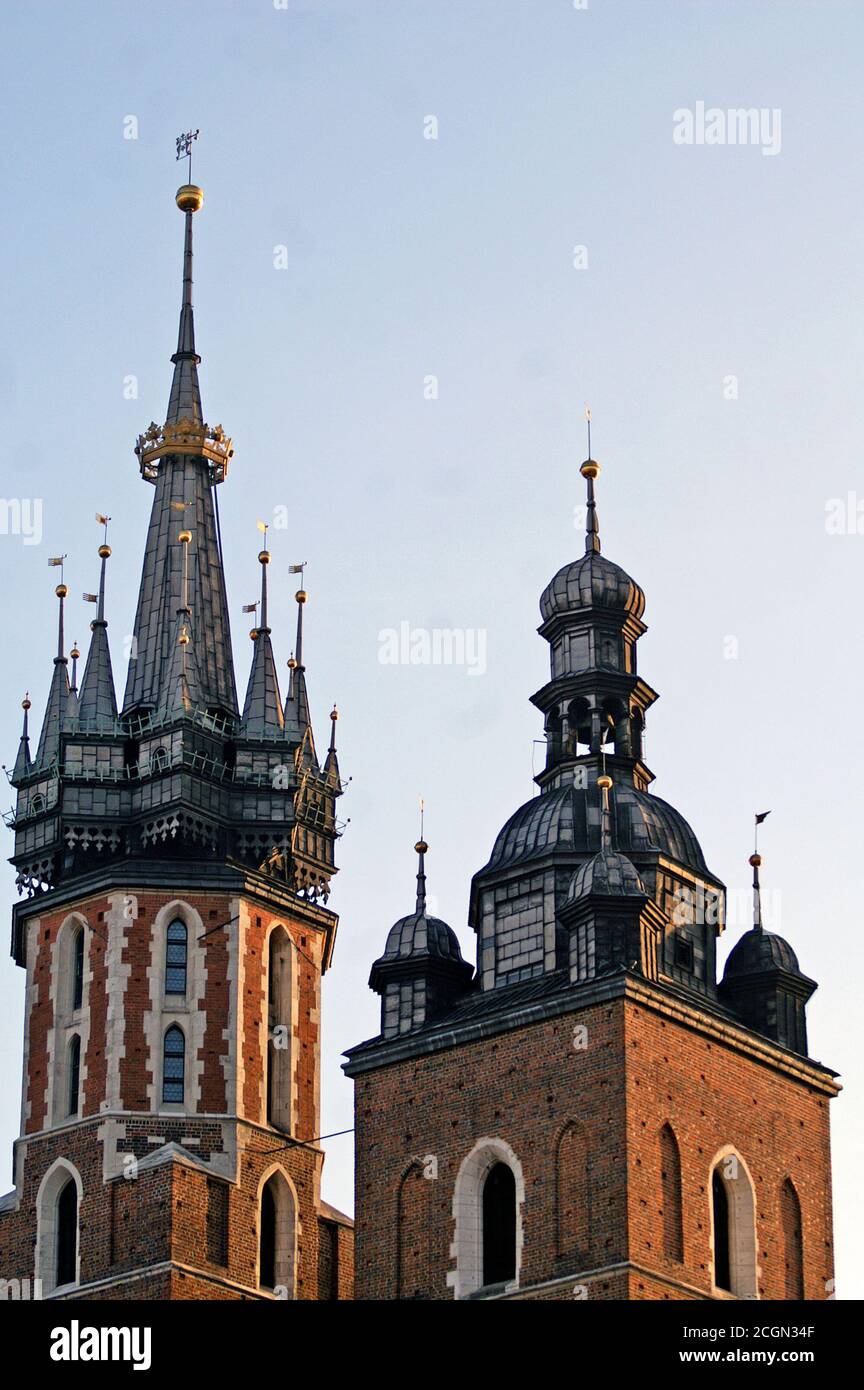 Top of the two Gothic towers, the bugle call tower and bell tower, of St. Mary Basilica in the old town of Krakow, Poland. Stock Photo
