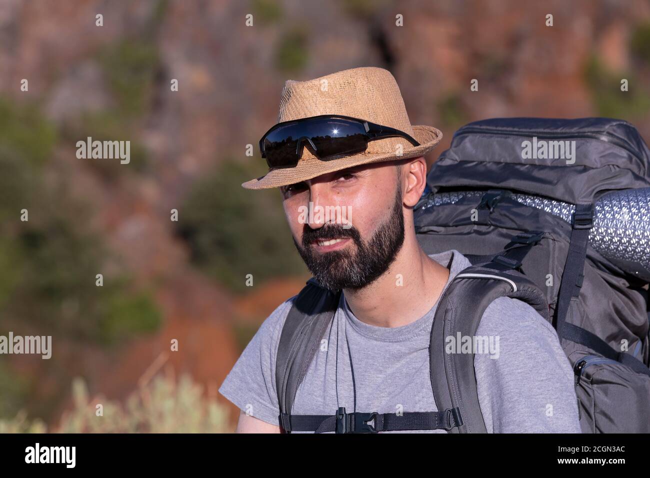 Handsome hispanic male trekker looking at camera Stock Photo