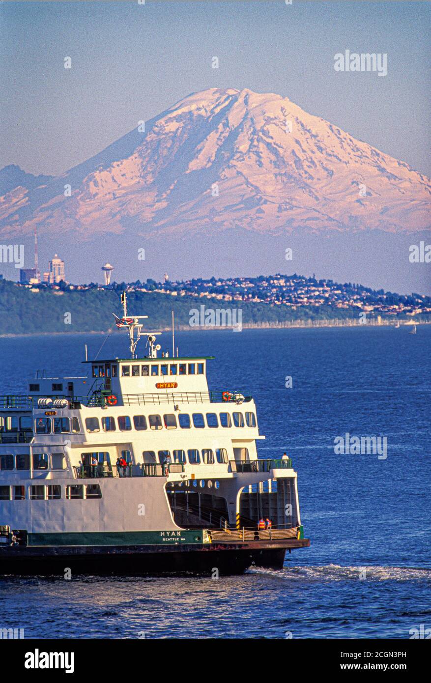 Washington State Ferry Boat on Puget Sound with Seattle skyline and Mount Rainier in background from Kingston, Washington USA Stock Photo