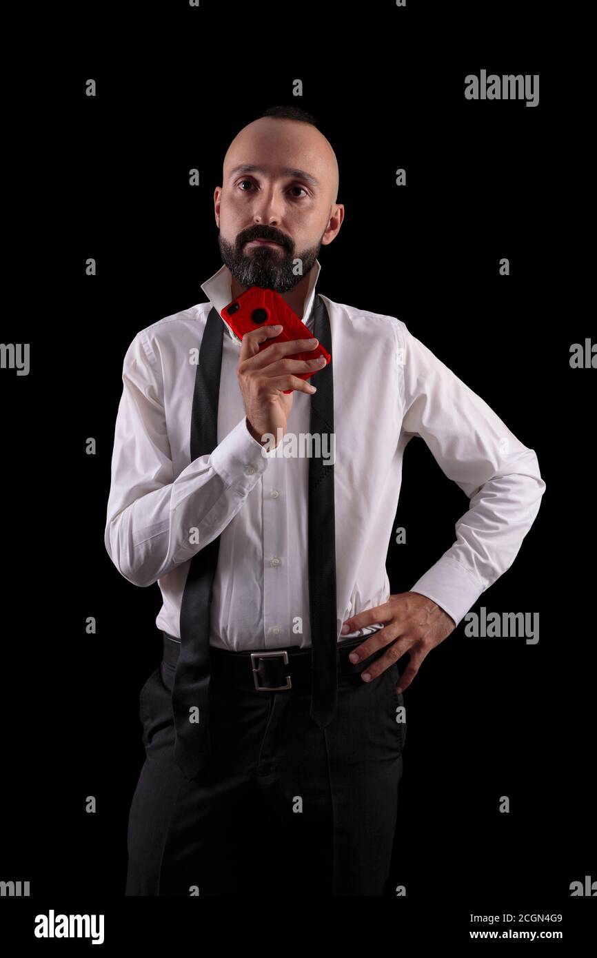 Pensive hispanic man with a red smartphone Stock Photo