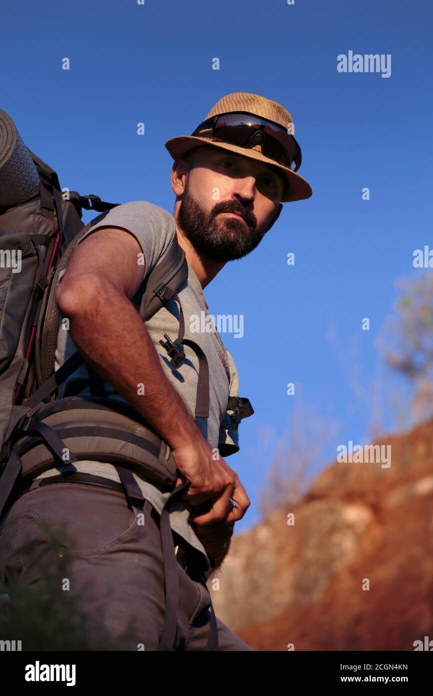 Curious young hispanic male hiker looking back Stock Photo
