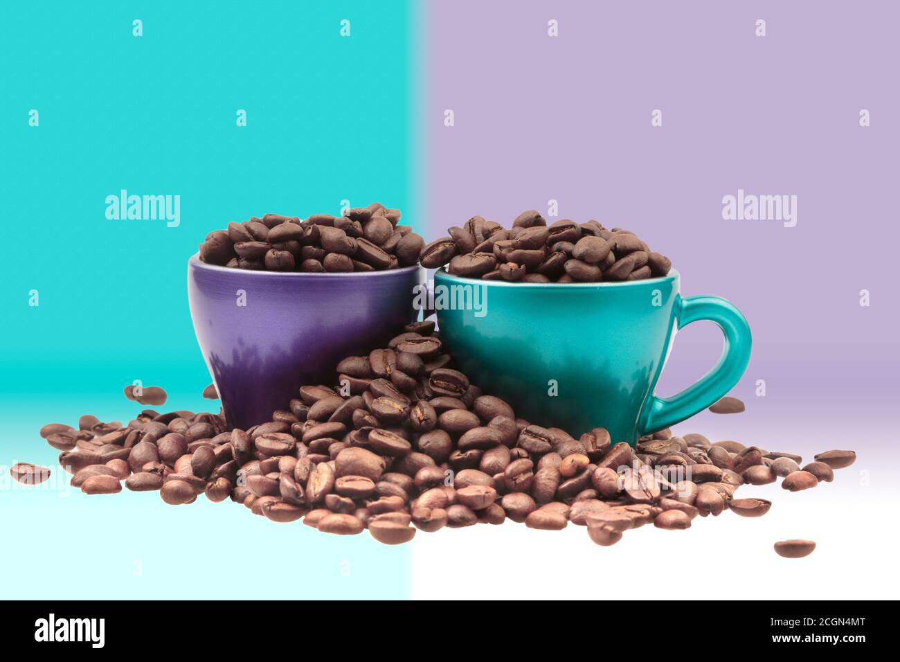Cups of coffee filled with grain in a heap of beans in pastel colors background Stock Photo