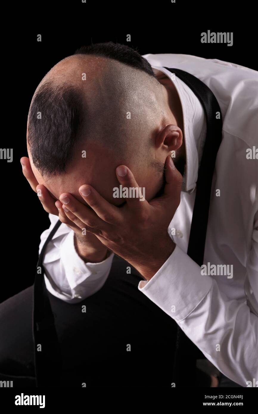 Close-up portrait of a desperate young caucasian male weeping Stock Photo