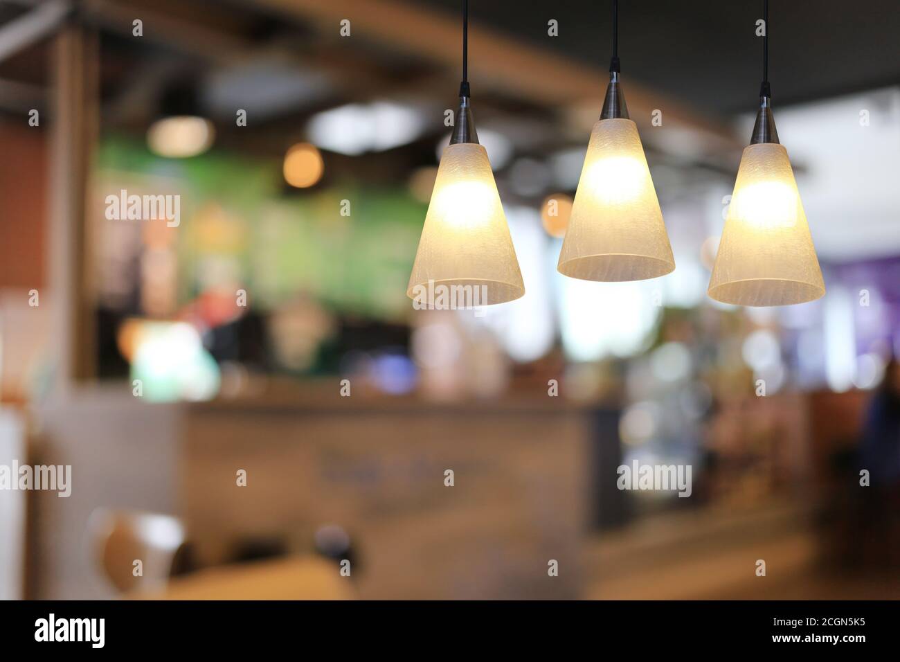 Modern lamp hanging from the ceiling of the restaurant for design in your work Interior concept. Stock Photo