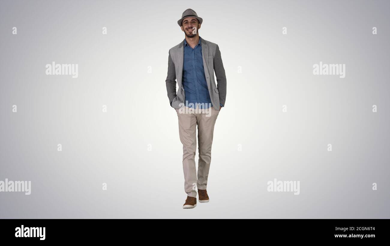 Young Asian tourist man wearing hat walking with hands in pocket Stock Photo