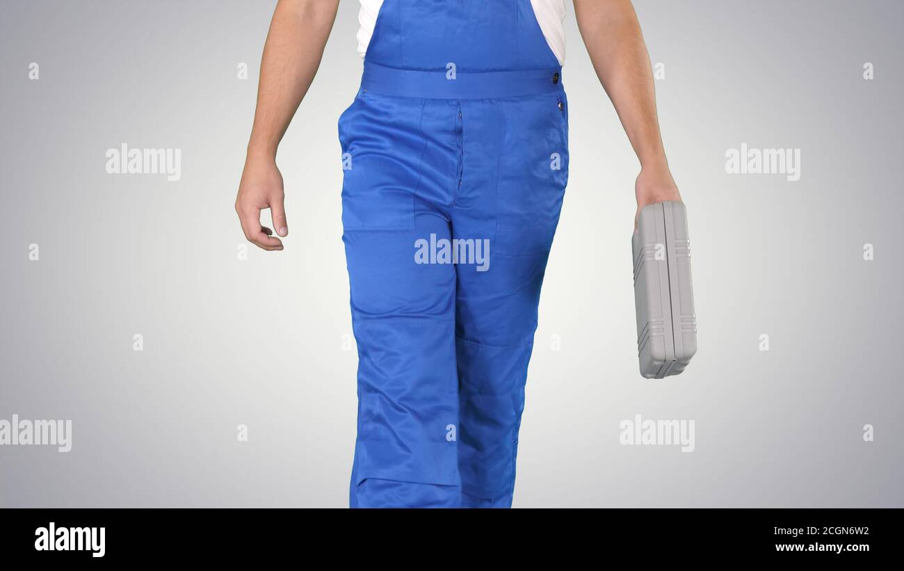 Carpenter walking on gradient background. Stock Photo