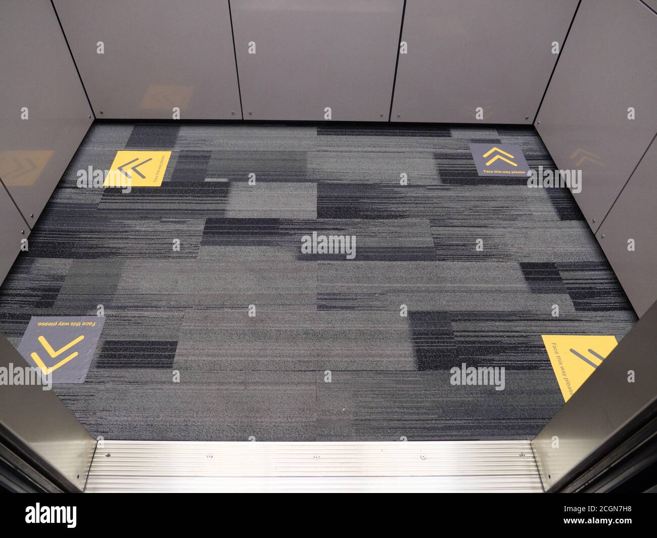 Social distancing markers on floor of parking garage elevator, Chicago, Illinois. Stock Photo