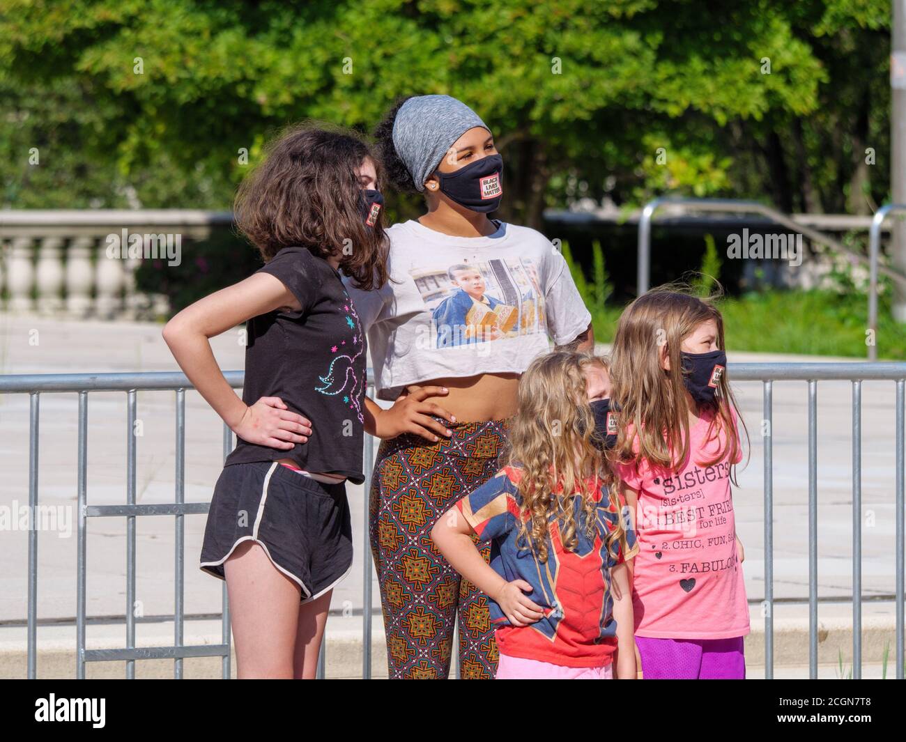 Young women and girls posing for photo, wearing face masks during COVID-19 pandemic. Millennium Park, Chicago, Illinois. Stock Photo