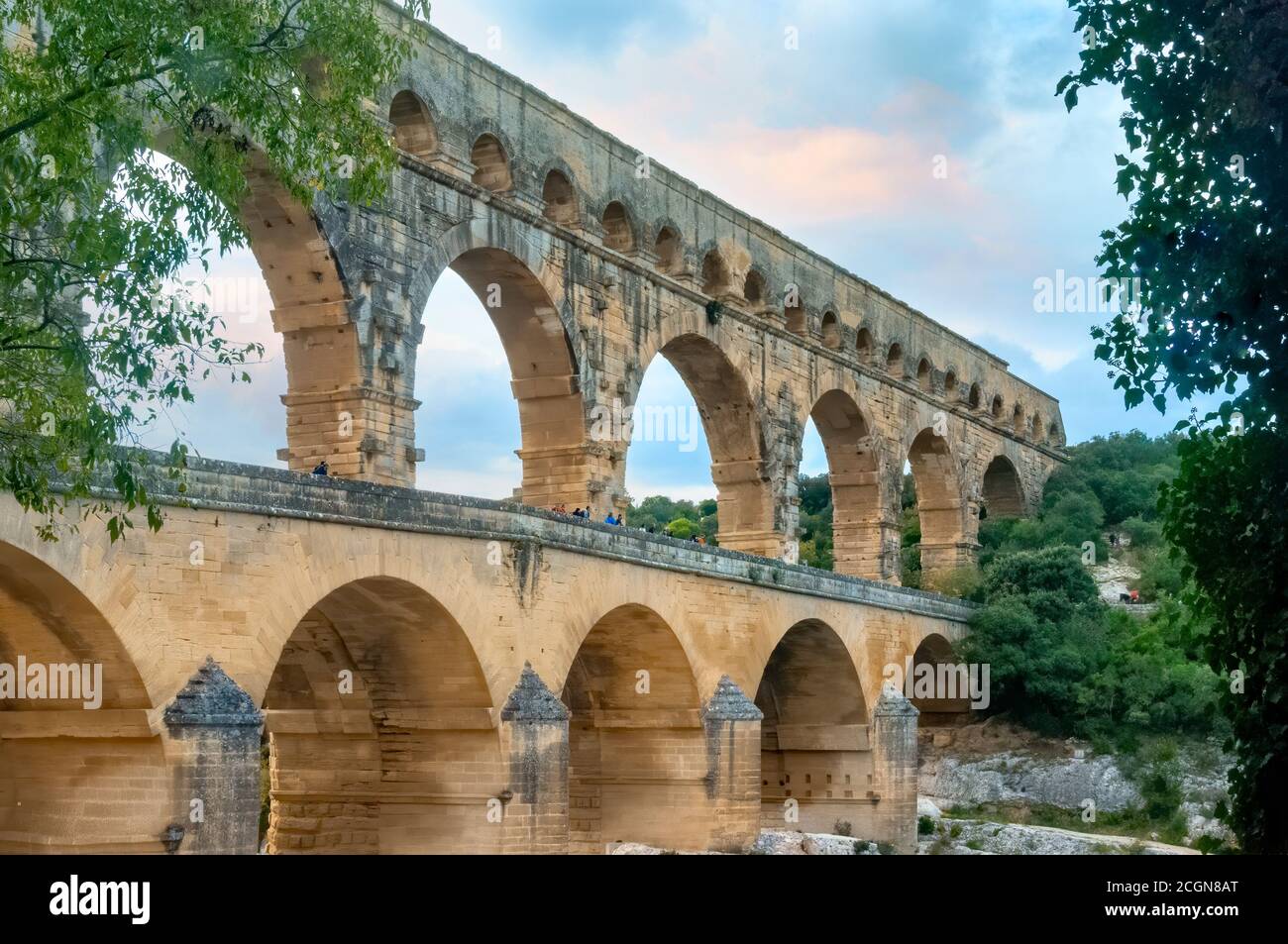 Three-tiered aqueduct Pont du Gard was built in Roman times on the river Gardon. Around the bridge is magnificent natural park. Provence, France. Stock Photo
