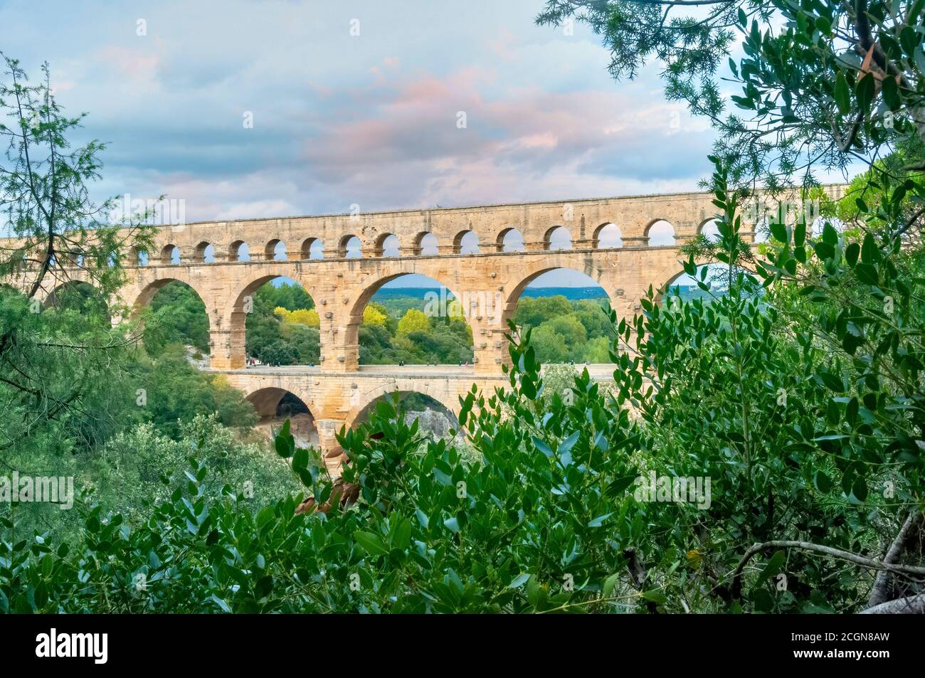 Three-tiered aqueduct Pont du Gard was built in Roman times on the river Gardon. Around the bridge is magnificent natural park. Provence, France. Stock Photo