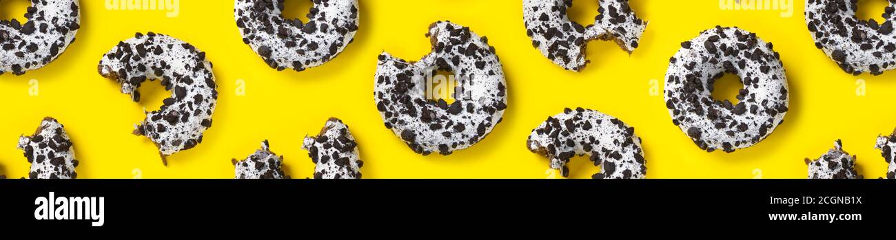 donuts on a yellow background top view. Flat lay of delicious nibbled ...