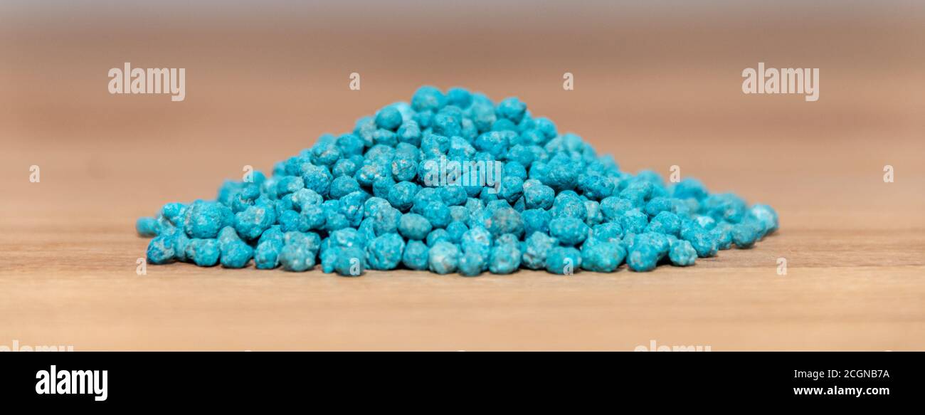 Fertilizer for plants. Blue balls of triple fertilizer 17. Agriculture Stock Photo