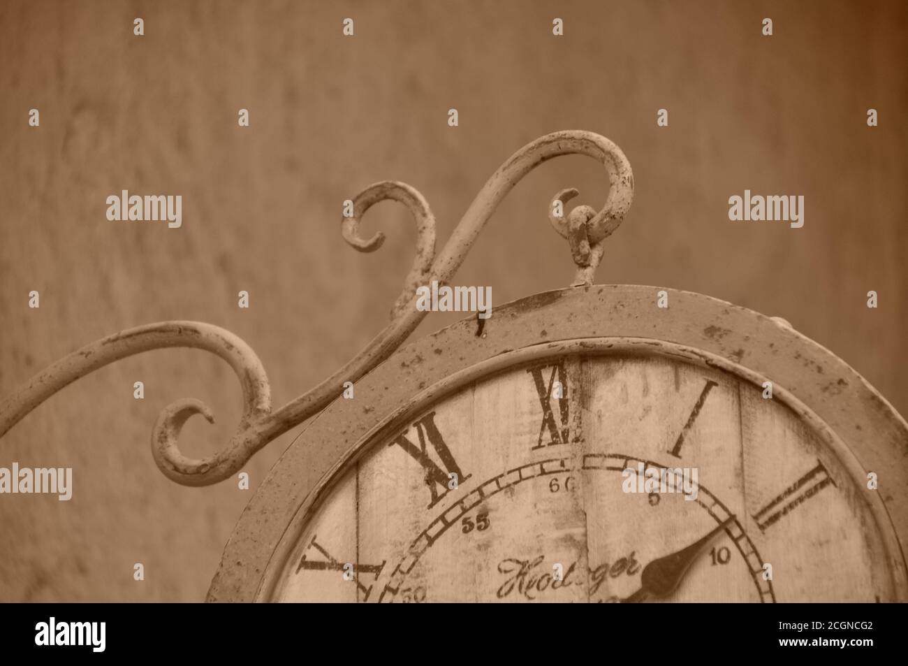 Vintage appeal roman numeral clock face hanging from outside wall