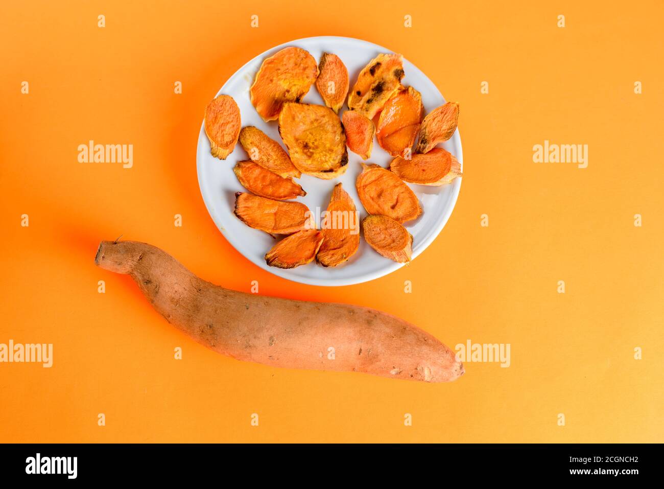 Top View White Dish Of Sliced And Raw Sweet Potatoes Healthy And Energy Athletic Food Thanksgiving Christmas Or Other Roasted Sweet Potatoes On The Grill Pan On The Plate Close Up Shot From Above