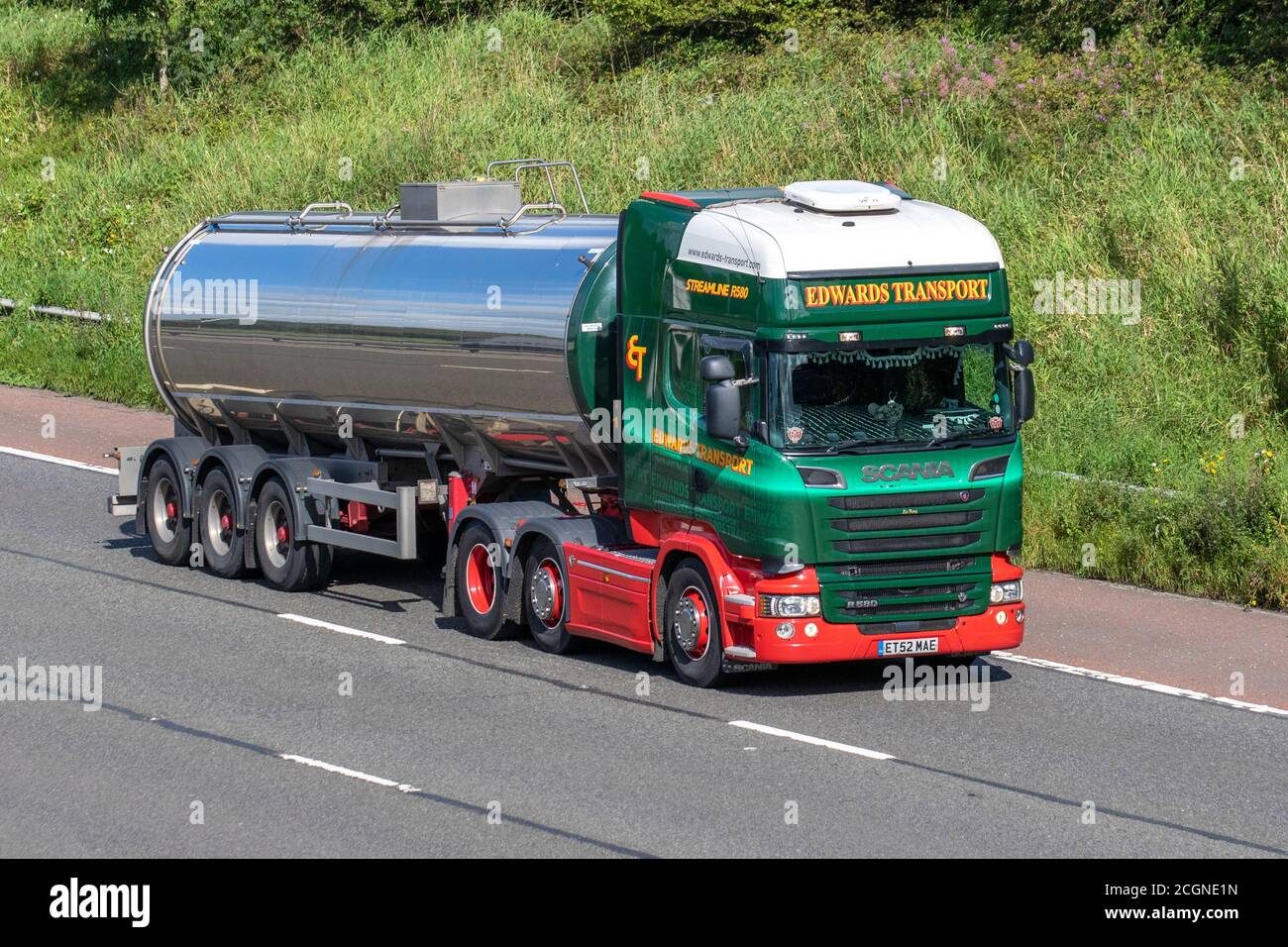 Edwards Transport green Haulage delivery trucks, tanker lorry, transportation, truck, bulk liquid milk tankers, food cargo carrier, Scania Streamline R580 vehicle, European commercial transport industry HGV, M6 at Manchester, UK Stock Photo
