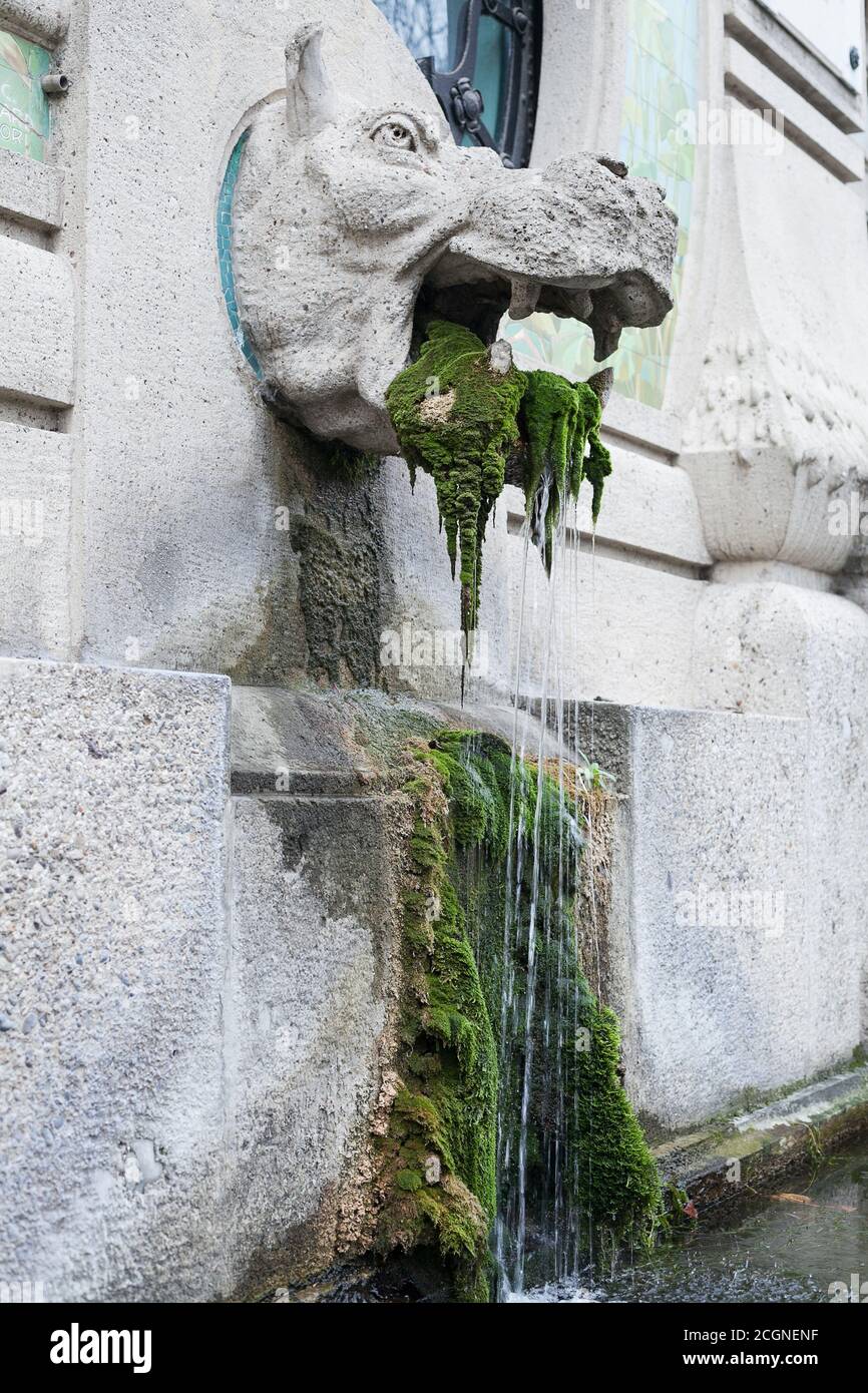 Fountain with statue of monster and moss Stock Photo