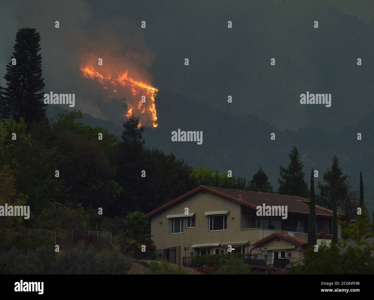 Monrovia, United Sates. 11th Sep, 2020. Flames from the Bobcat Fire appear above homes in the foothills of Monrovia, California on Friday, September, 11, 2020. The wildfire burning in the Angeles National Forest has blackened more than 26,000 acres and is only 6% contained. Full containment is not expected until Oct. 15. Photo by Jim Ruymen/UPI Credit: UPI/Alamy Live News Stock Photo