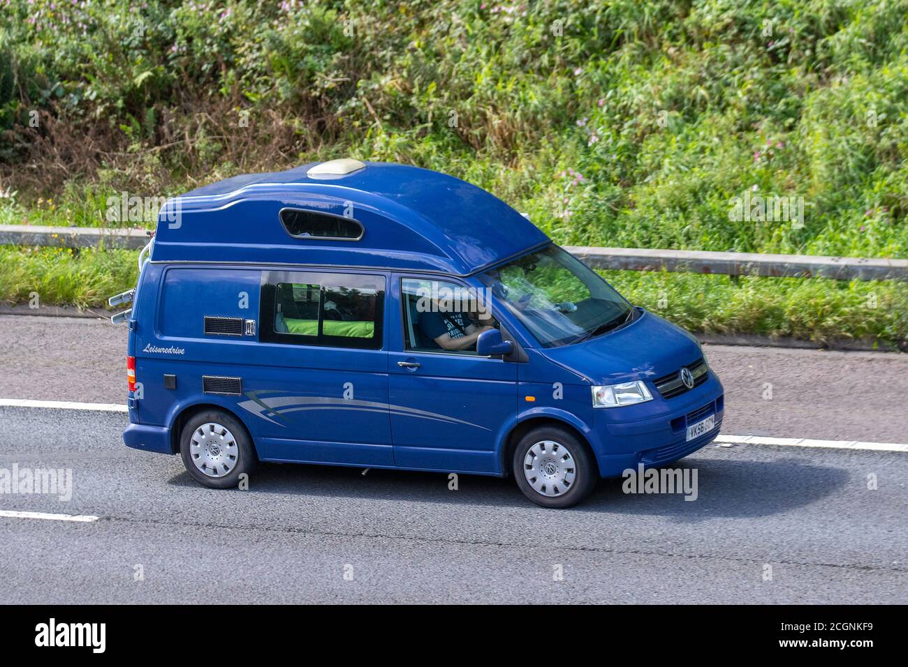 VW VolkswagenT6 van with factory fitted hi-top roof  Vehicular traffic moving vehicles, cars driving vehicle on UK roads, Leisuredrive Freespirit motors, motoring on the M6 motorway highway network. Stock Photo