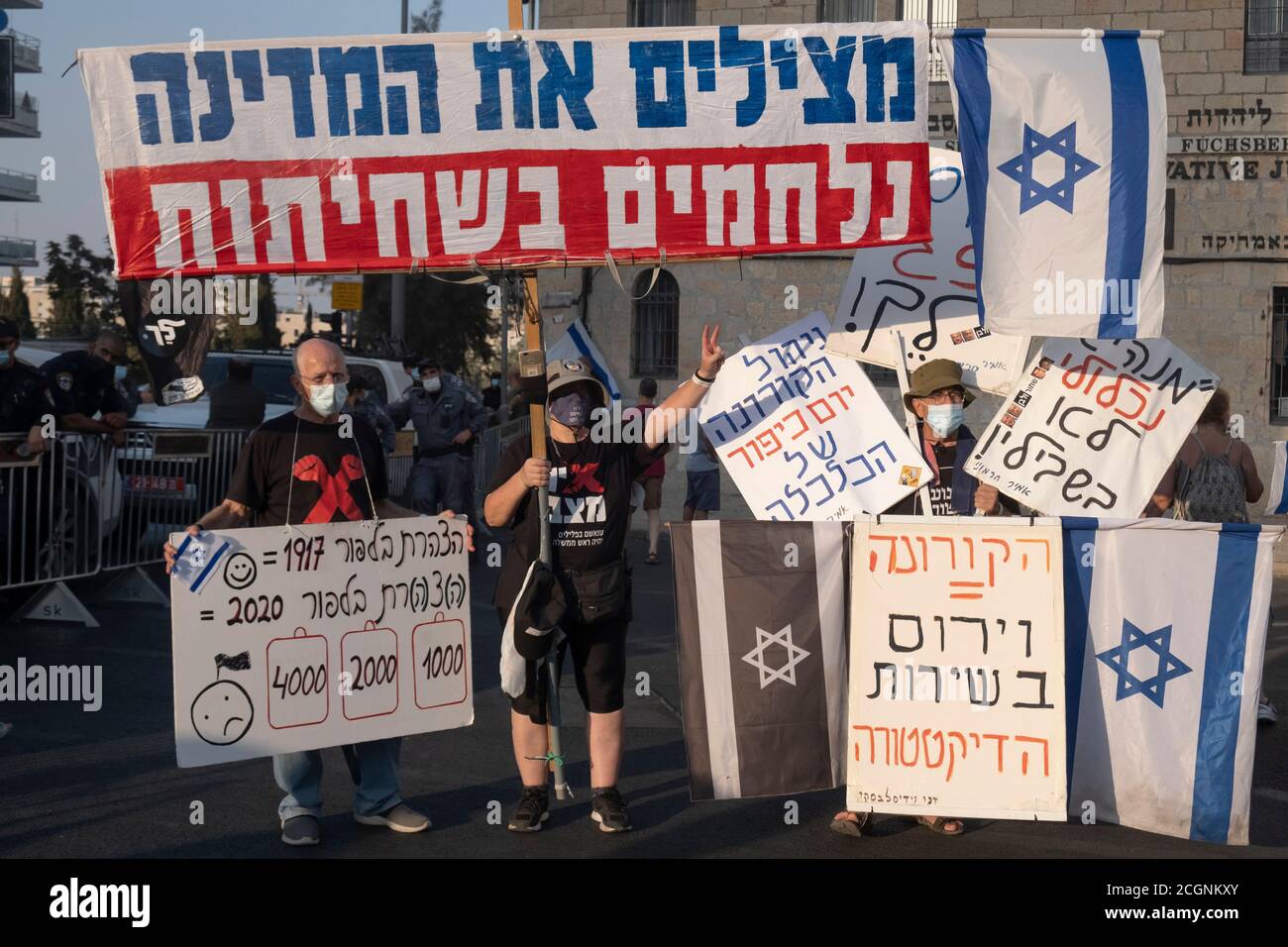 JERUSALEM, ISRAEL - SEPTEMBER 11: Protesters hold placards during a demonstration near prime minister's official residence as part of ongoing demonstrations for the 12th consecutive week against Prime Minister Benjamin Netanyahu over his indictment on corruption charges and handling of the coronavirus pandemic on September 11, 2020 in Jerusalem, Israel. A wave of anti-Netanyahu protests has swept Israel over the summer, with the largest weekly demonstration taking place every weekend in Jerusalem. Stock Photo