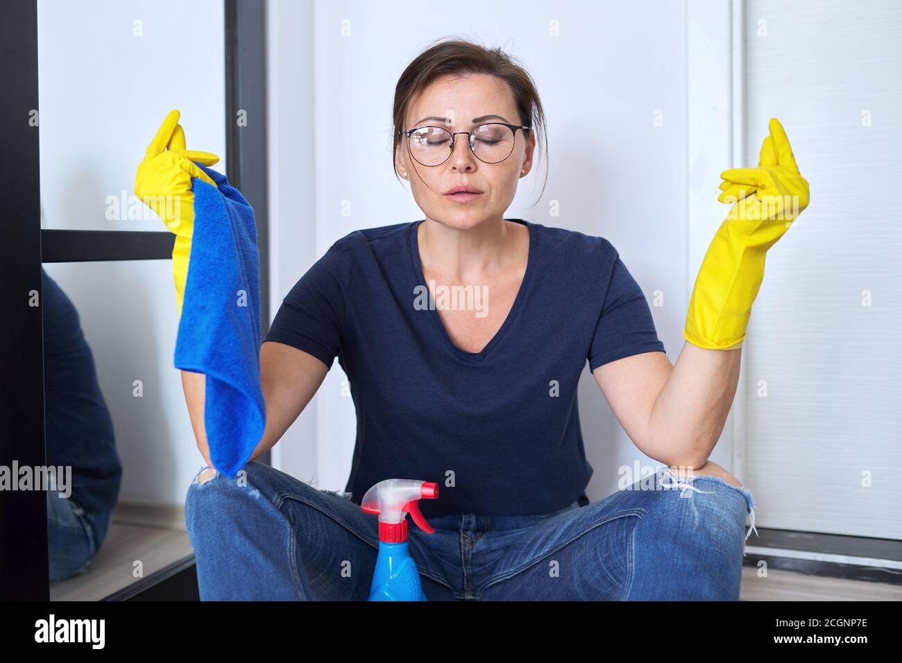 Sad tired meditating woman in gloves with detergent and rag Stock Photo ...