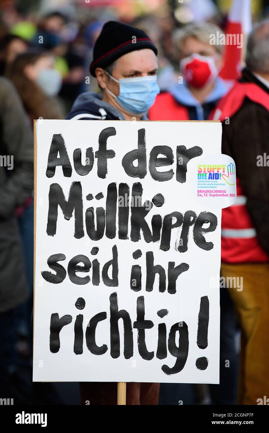 Brunswick, Germany. 12th Sep, 2020. A participant in a demonstration against the state party conference of the Party Alternative for Germany (AfD) holds a poster with the inscription 'Auf der Müllkippe seid ihr richtig! The AfD of Lower Saxony will hold its state party conference at the Millennium Event Center. A new executive committee is to be elected. Credit: Swen Pförtner/dpa/Alamy Live News Stock Photo