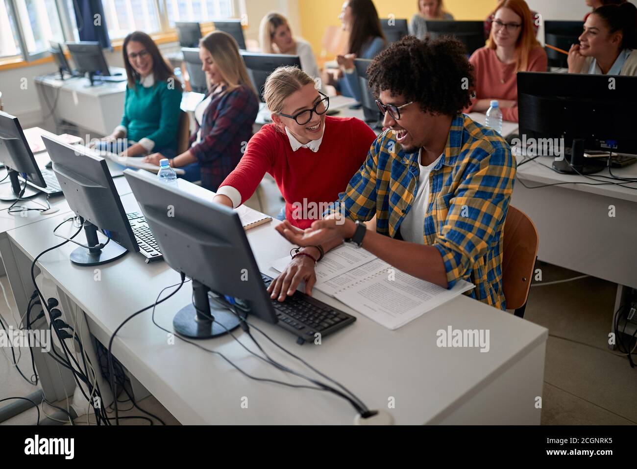 Students having fun at an informatics lecture in the university computer classroom Stock Photo