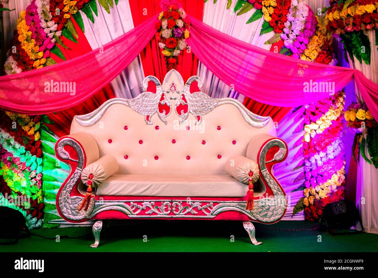 Wedding or wedding reception sitting purpose stage for bride & groom  decorated with flowers and royal sofa Stock Photo - Alamy
