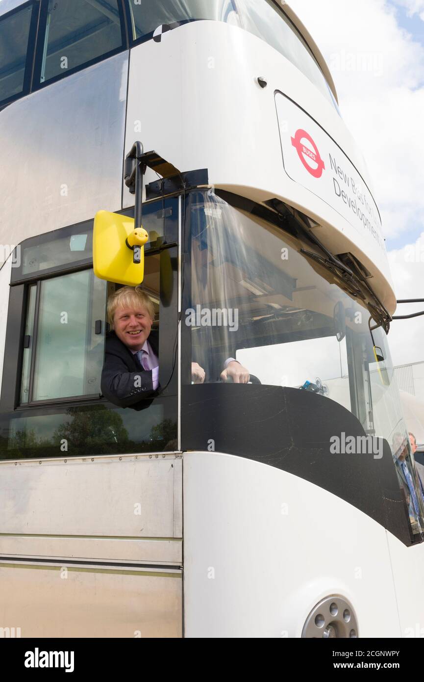 Boris Johnson Mayor of London driving a prototype of the New Bus for London at the press launch. The bus which is undergoing trials at the Millbrook Proving Ground vehicle testing centre located at Millbrook, Bedfordshire. The bus late became know as New Routemaster and was nick named the Boris Bus.   The New Bus for London, is a hybrid diesel-electric double-decker bus operated in London, Designed by Heatherwick Studio and manufactured by Wrightbus, it is notable for featuring a 'hop-on hop-off' rear open platform similar to the original Routemaster bus design but updated to meet requirements Stock Photo