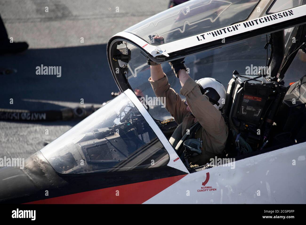 A student naval aviator prepares to close the canopy of a T45C Goshawk