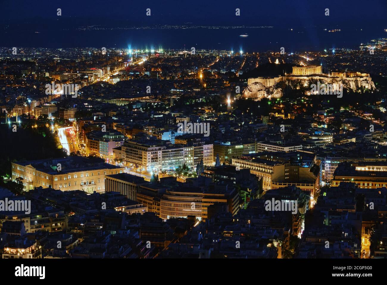 Night view of Athens and Acropolis, Parthenon and Erechtheion, Hellenic Parliament in city lights. Famous iconic view of UNESCO world heritage site. Stock Photo