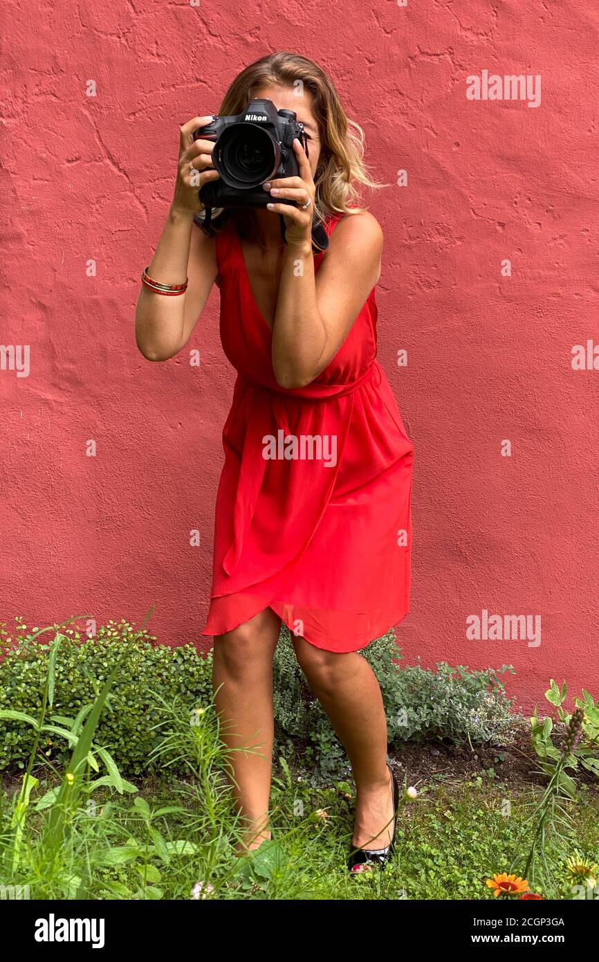 Young woman in red dress, photographed with professional DSLR, Karsruhe, Baden-Wuerttemberg, Germany Stock Photo