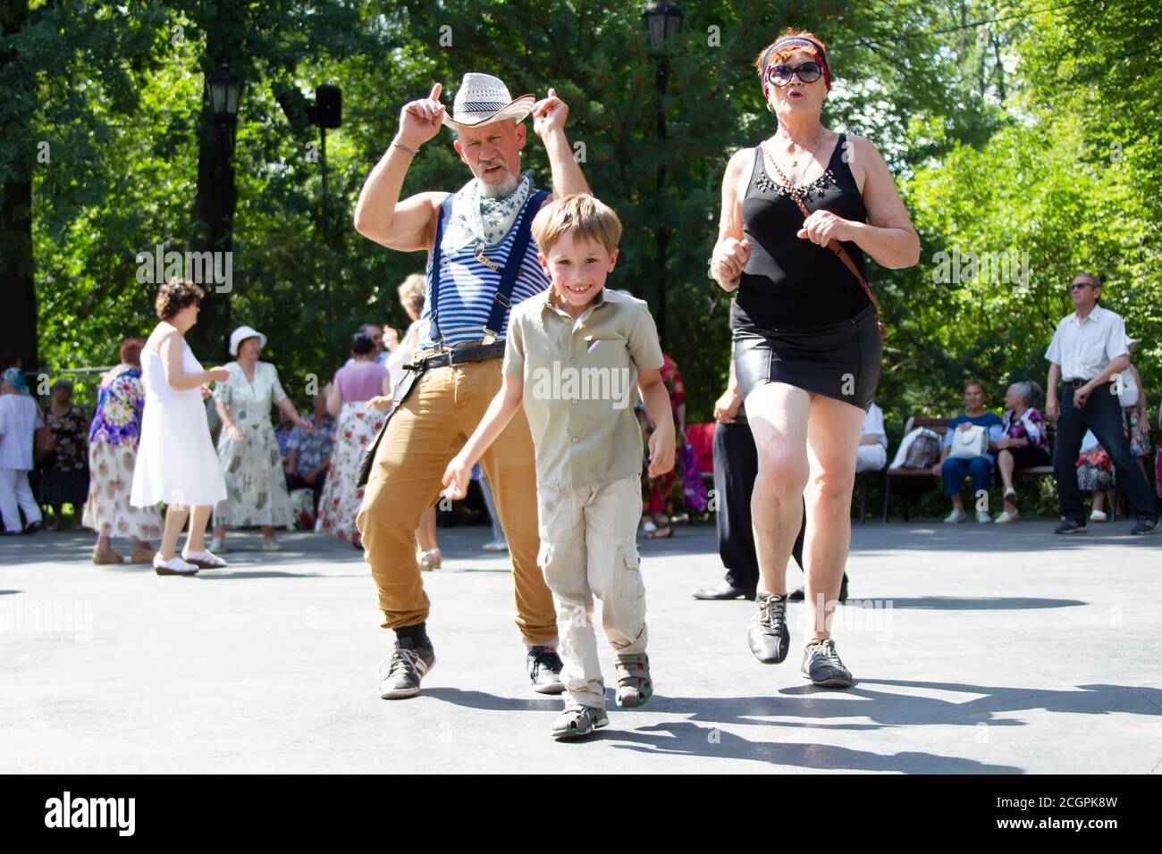 Grandfather and grandson are dancing on the dance floor. Stock Photo