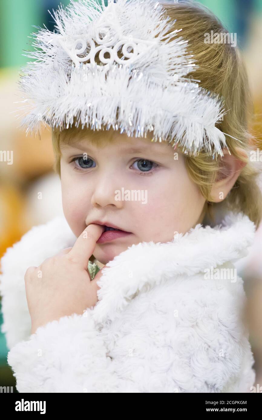 Portrait of a little girl with a Christmas crown. Stock Photo